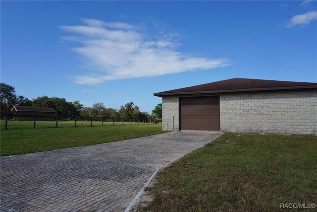 garage featuring a lawn