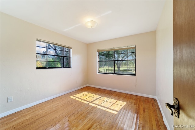 empty room with light hardwood / wood-style flooring