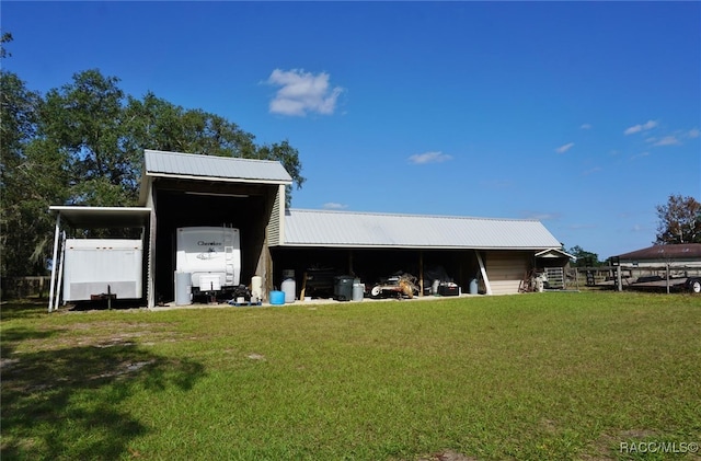 view of outbuilding featuring a lawn