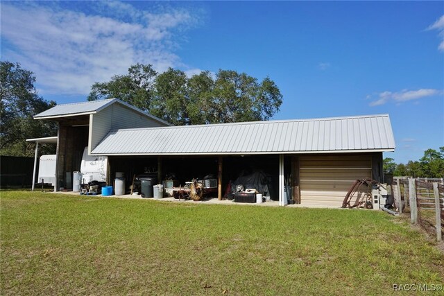 view of outbuilding featuring a yard