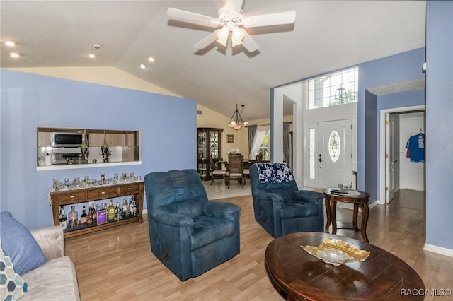 living room featuring ceiling fan, hardwood / wood-style floors, and lofted ceiling