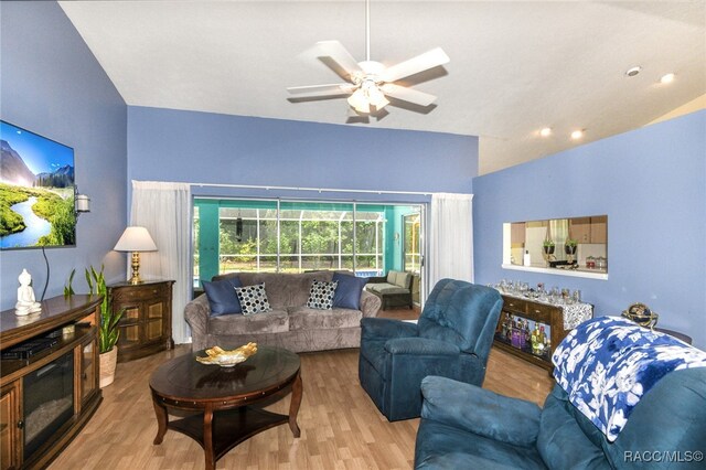 living room featuring ceiling fan and hardwood / wood-style flooring