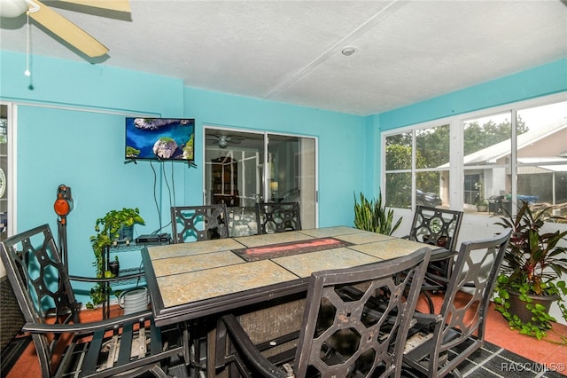 carpeted dining space with a textured ceiling