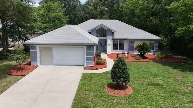 view of front of home featuring a garage and a front lawn