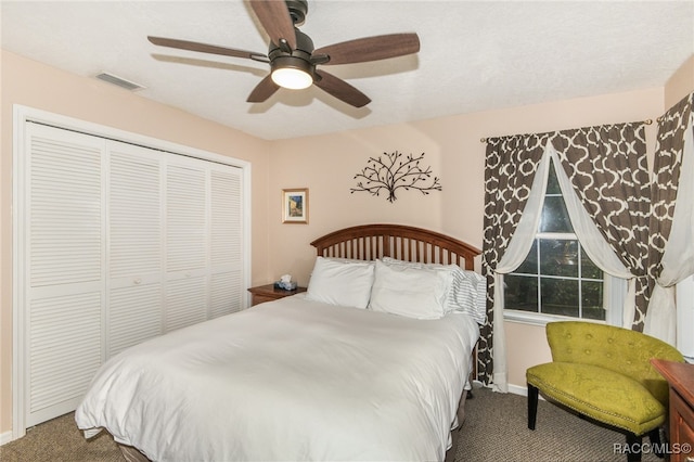 carpeted bedroom featuring ceiling fan and a closet