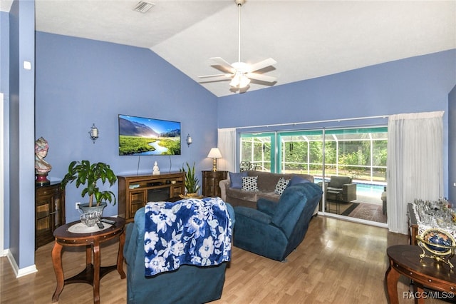 living room featuring ceiling fan, vaulted ceiling, and hardwood / wood-style flooring