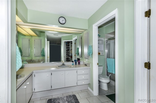 bathroom featuring tile patterned flooring, vanity, and toilet