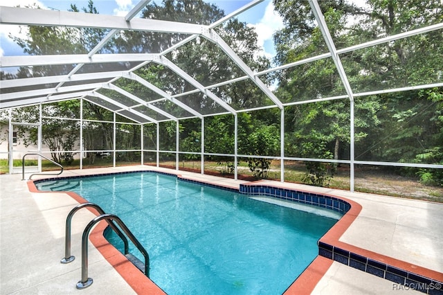 view of swimming pool with a lanai and a patio