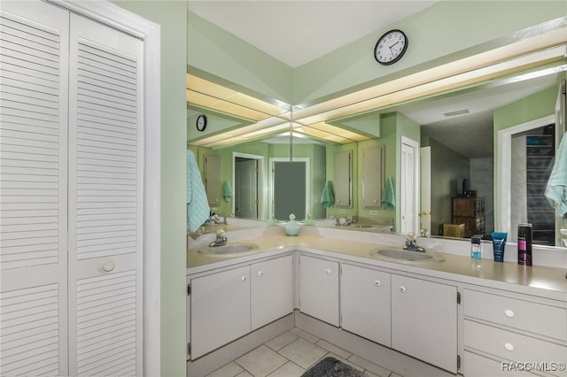 bathroom featuring vanity, tile patterned floors, and lofted ceiling