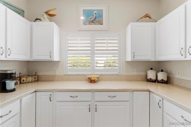 251 W Rexford Dr, Beverly Hills, FL 34465 - kitchen with light countertops and white cabinets