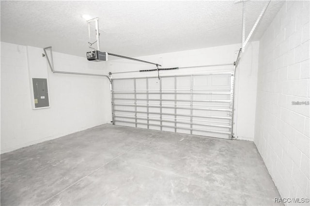 garage featuring electric panel and a garage door opener