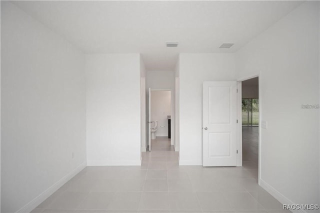 spare room featuring light tile patterned floors