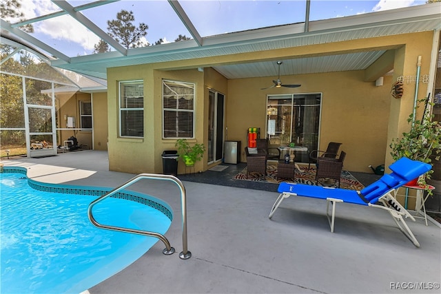 view of swimming pool featuring outdoor lounge area, a lanai, ceiling fan, and a patio area