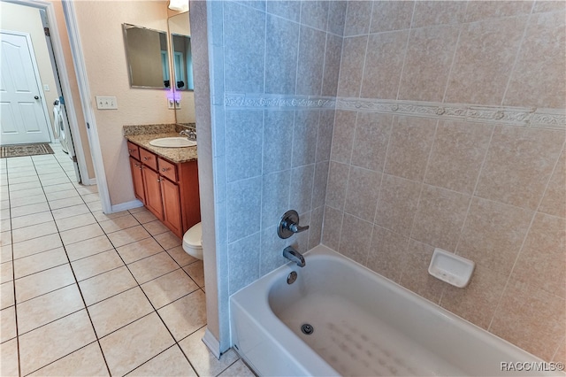 full bathroom featuring tile patterned flooring, vanity, toilet, and tiled shower / bath combo