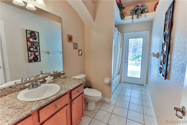 full bathroom featuring tile patterned flooring, vanity, shower / bath combo, and toilet