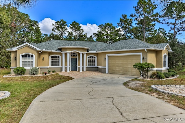 ranch-style home with a front lawn and a garage