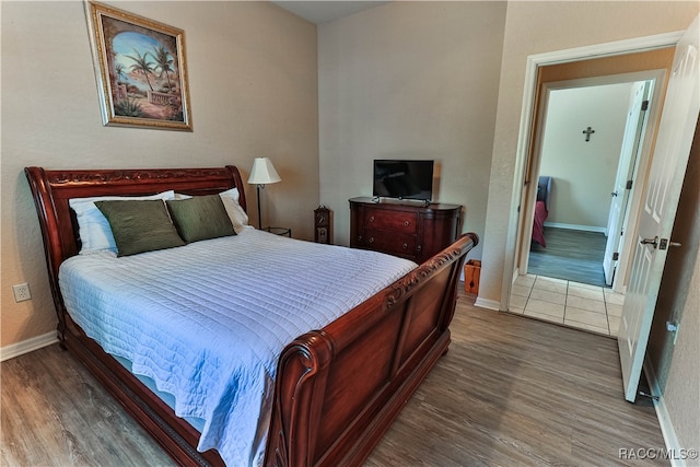 bedroom with wood-type flooring