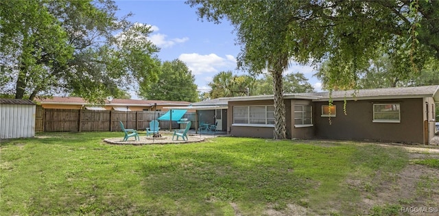 4 S Columbus St, Beverly Hills, FL 34465 - rear view of house featuring an outdoor fire pit, a patio, stucco siding, and a storage unit
