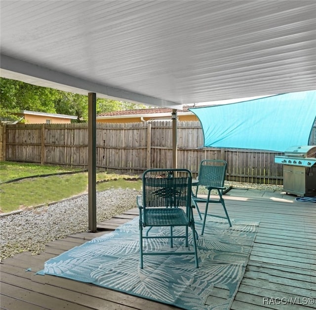 4 S Columbus St, Beverly Hills, FL 34465 - wooden terrace with area for grilling and a fenced backyard