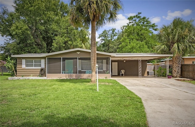 4 S Columbus St, Beverly Hills, FL 34465 - ranch-style house featuring driveway, an attached carport, and a sunroom
