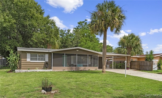 4 S Columbus St, Beverly Hills, FL 34465 - view of front facade featuring a sunroom, an attached carport, and driveway