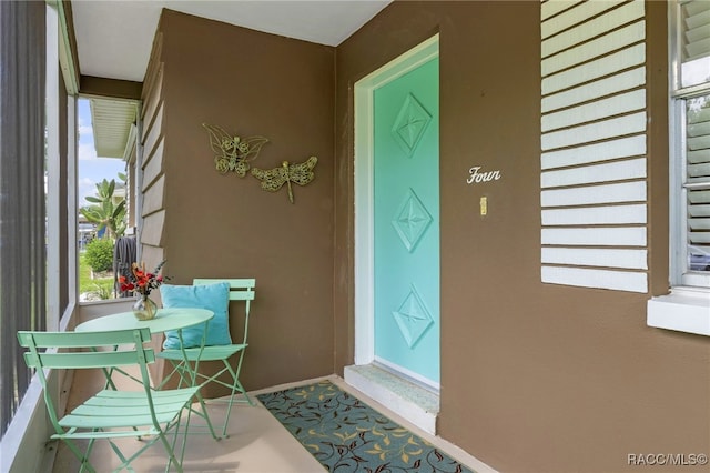 4 S Columbus St, Beverly Hills, FL 34465 - doorway to property featuring stucco siding and covered porch