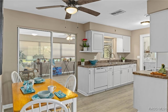 4 S Columbus St, Beverly Hills, FL 34465 - kitchen with independent washer and dryer, a ceiling fan, dark countertops, white cabinetry, and light wood-type flooring