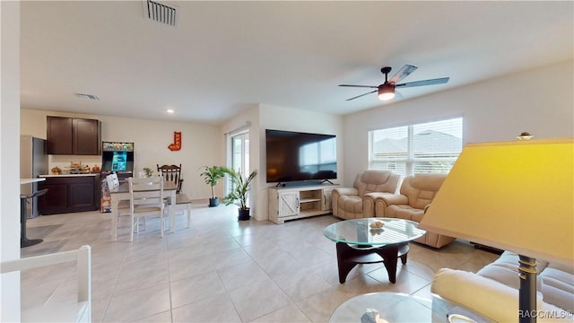 living room featuring ceiling fan and light tile patterned flooring