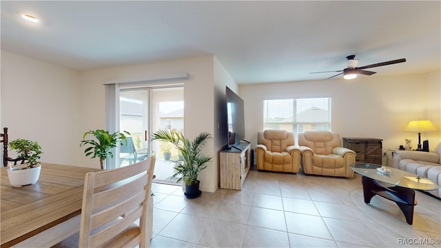 living room featuring ceiling fan and light tile patterned flooring