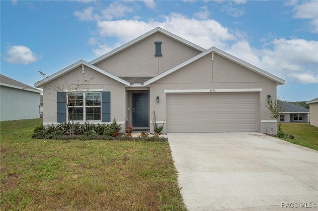 single story home featuring a garage and a front lawn