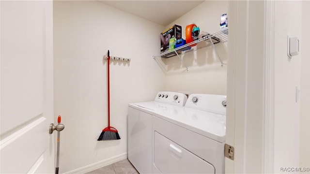 clothes washing area featuring light tile patterned floors and separate washer and dryer