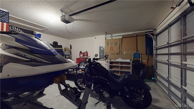 garage featuring electric panel and a garage door opener