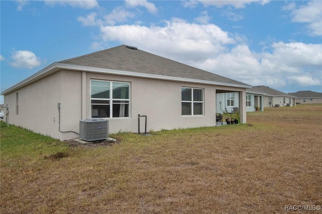 view of property exterior featuring a yard and central AC