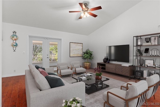 living room with baseboards, ceiling fan, vaulted ceiling, french doors, and wood finished floors