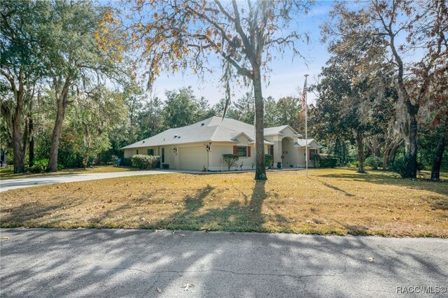 view of front of property with a garage and a front yard