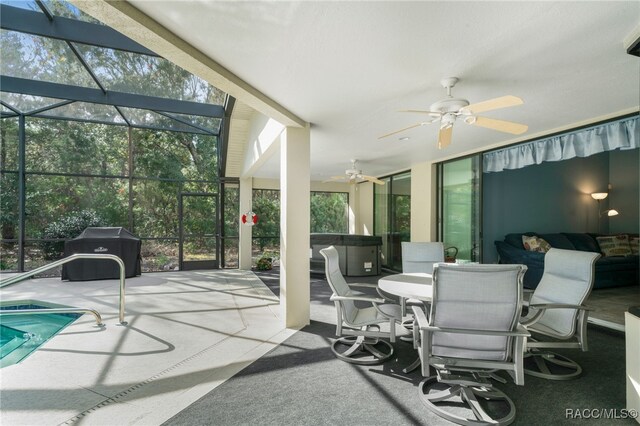 sunroom / solarium featuring ceiling fan