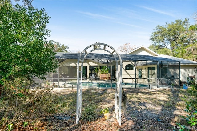 view of swimming pool with a patio and glass enclosure