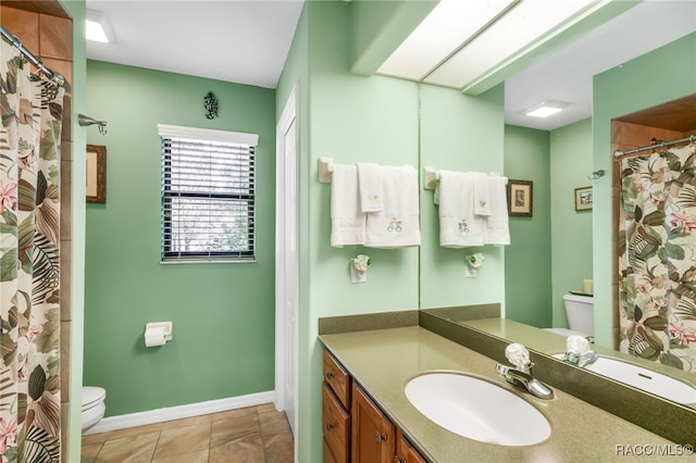 bathroom featuring tile patterned flooring, vanity, walk in shower, and toilet