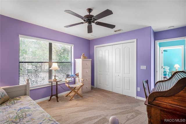 living area with ceiling fan and light colored carpet