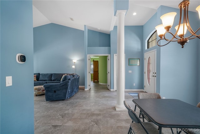 interior space featuring high vaulted ceiling, a notable chandelier, and decorative columns