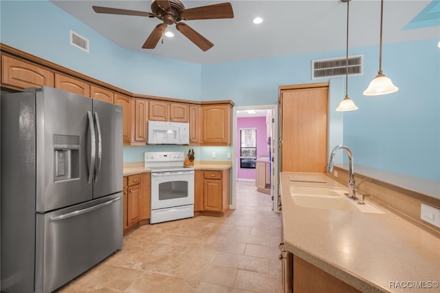 kitchen with pendant lighting, sink, white appliances, and ceiling fan