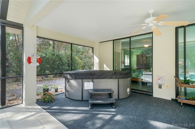 unfurnished sunroom with ceiling fan