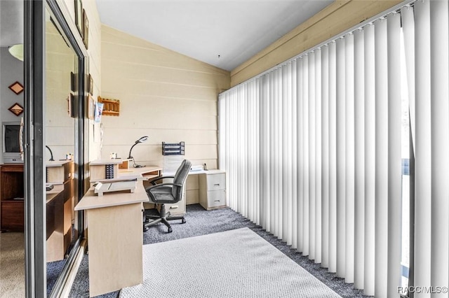 office area featuring lofted ceiling and light colored carpet