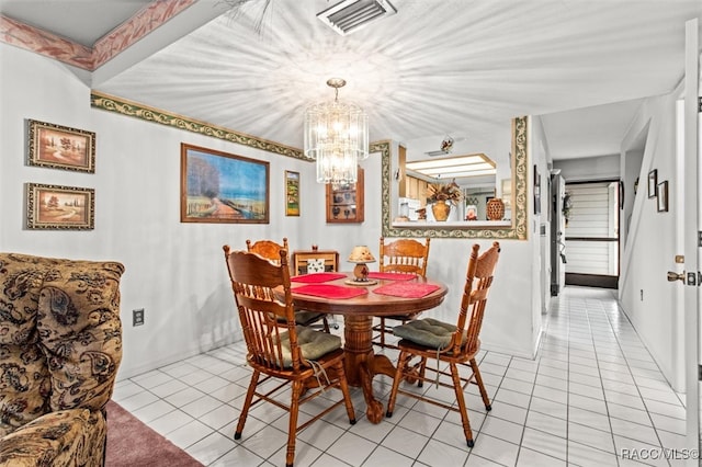 dining area with light tile patterned floors, a chandelier, and visible vents