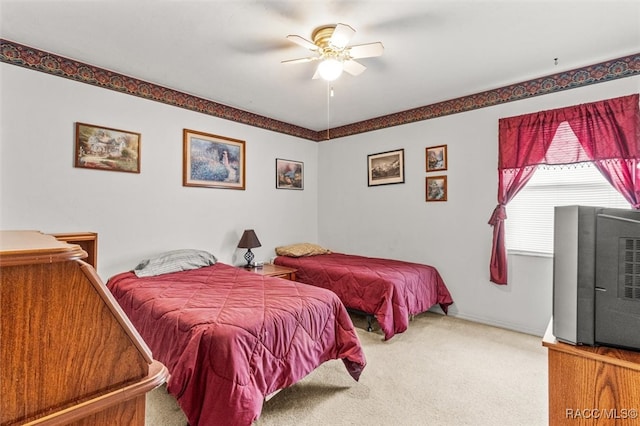 bedroom with a ceiling fan and carpet flooring