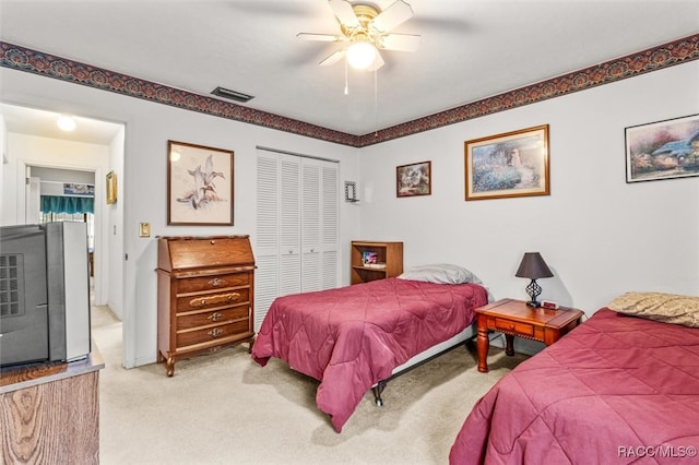 bedroom featuring carpet floors, a closet, and ceiling fan