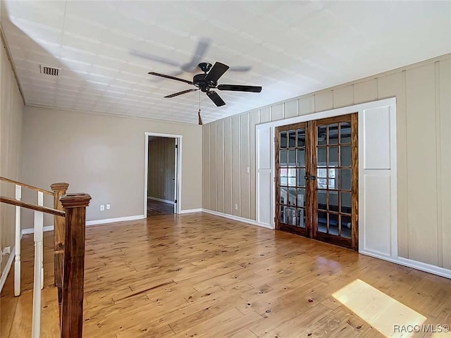 unfurnished room featuring french doors, ceiling fan, and light wood-type flooring