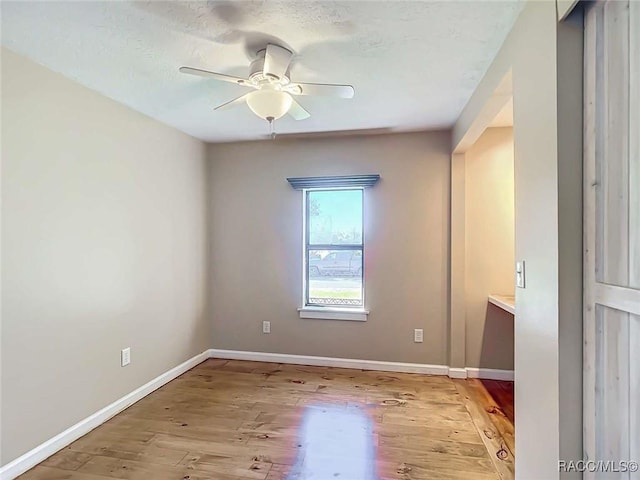 empty room featuring ceiling fan and light hardwood / wood-style floors