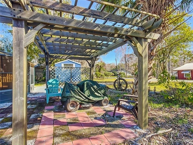 view of patio with a shed and a pergola