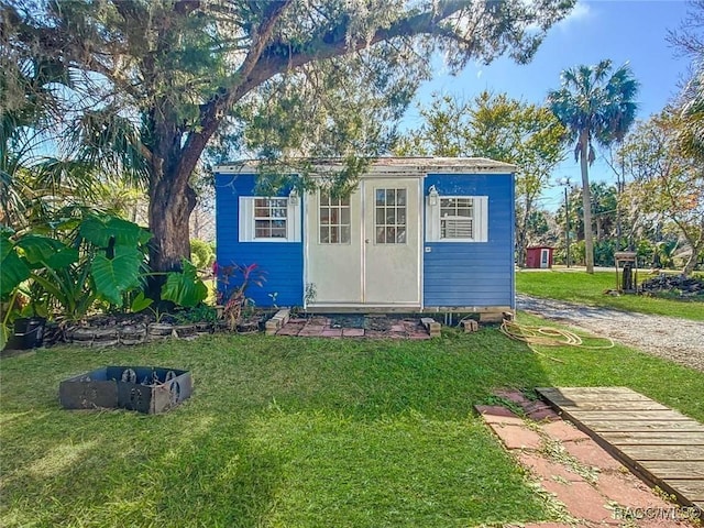 view of outbuilding featuring a lawn